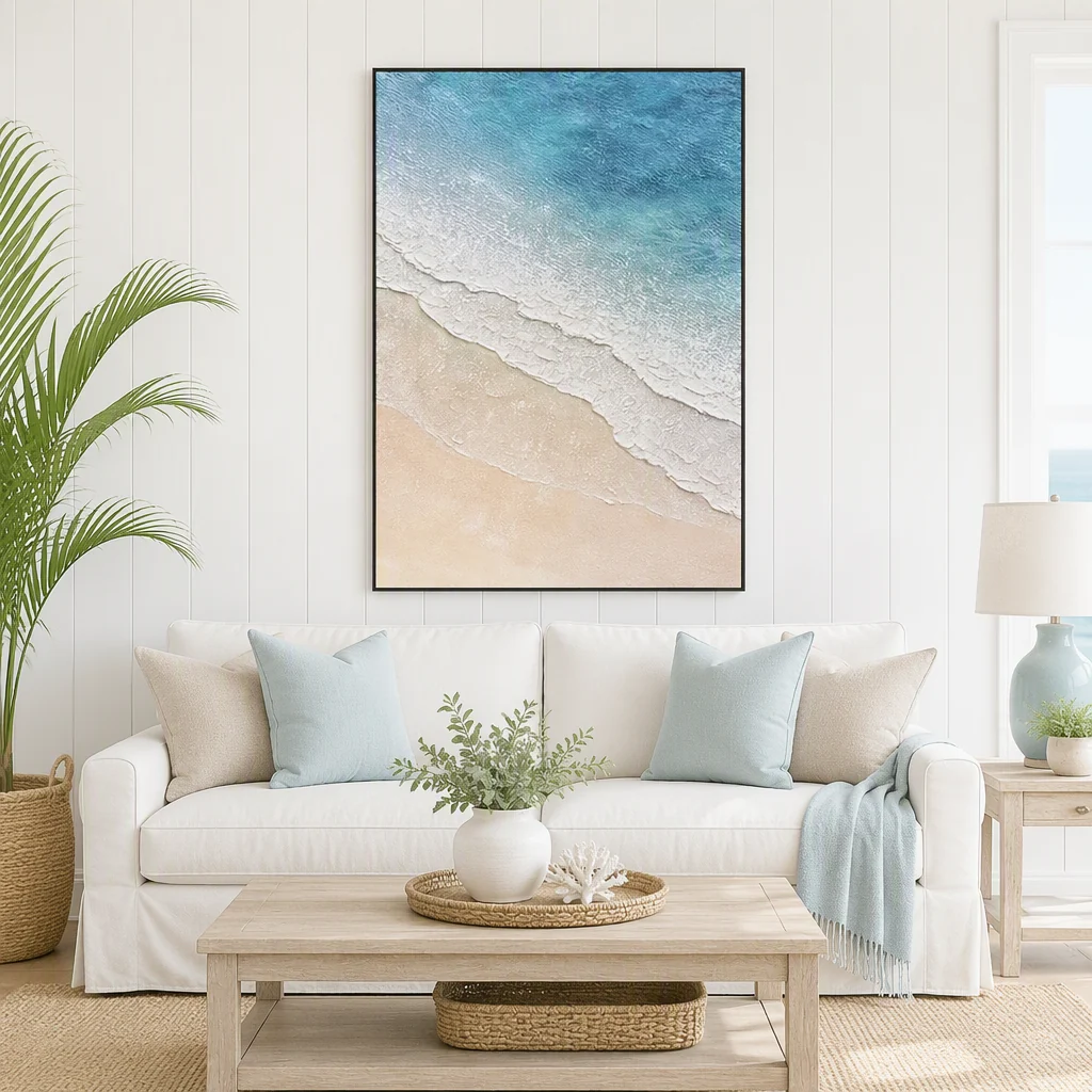 Framed hand-painted coastal oil painting with textured turquoise water and pale sandy shoreline on a white panelled wall