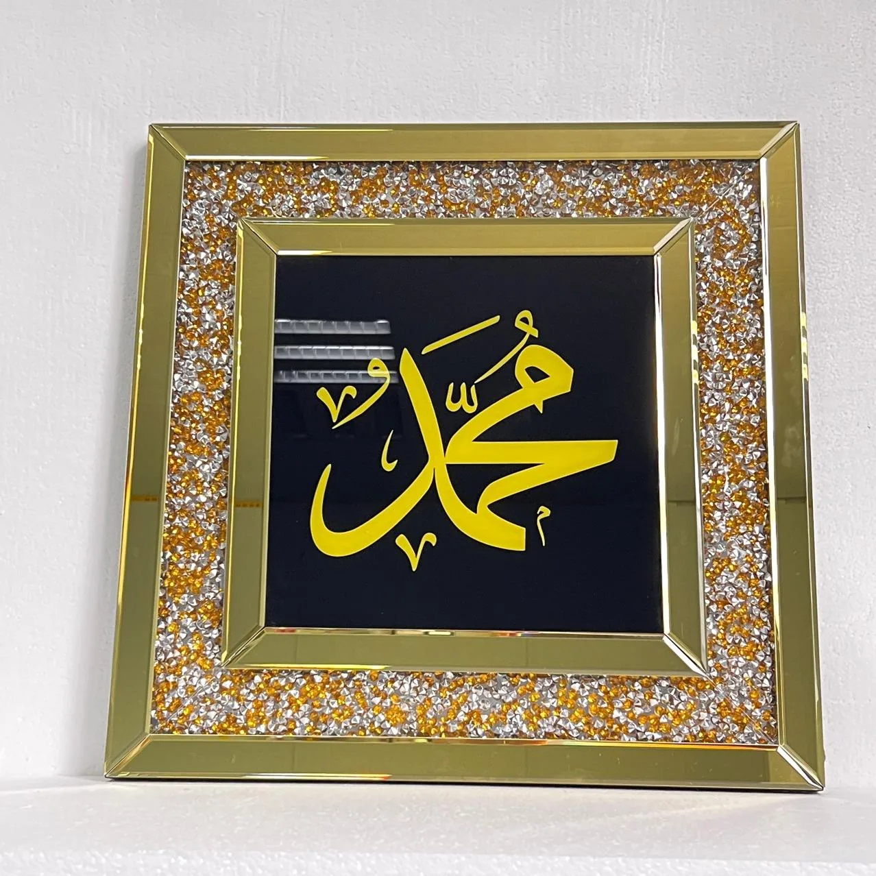 Arabic calligraphy wall art with the Prophet Muhammad's name in gold frame with crystal detailing for Islamic hospitality projects