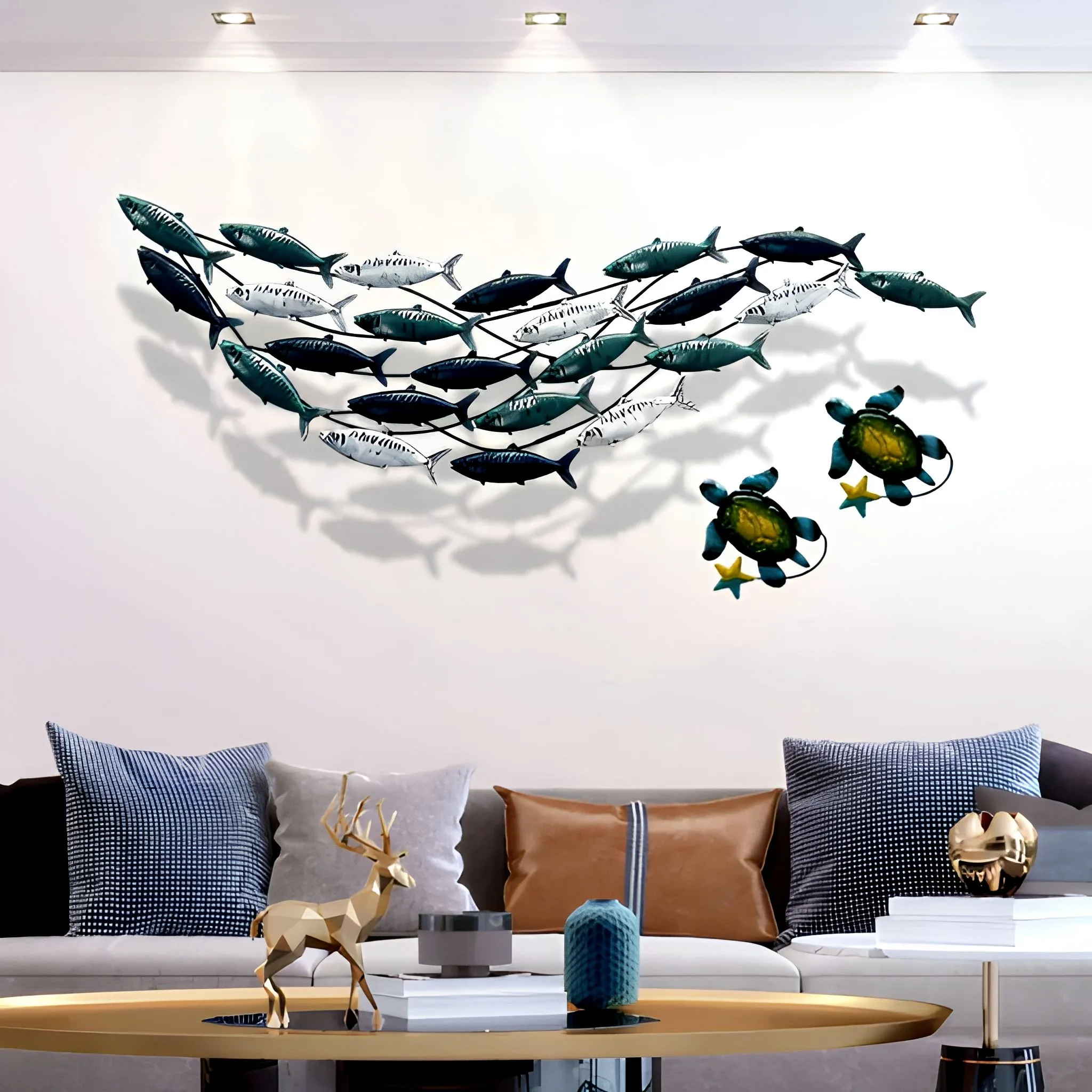 A Mediterranean-style metal wall art of a shoal of fish in green, white and deep blue metal finishes on a light wall, showing surface finish direction relevant to a finish approval